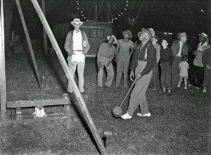 A carnival-goer plays a test-of-strength game during the Russell Bro. Circus during the 1940s. Scanned Negative. By J.B. Muecke. (Click on the image to enlarge.) 2012.022.3071