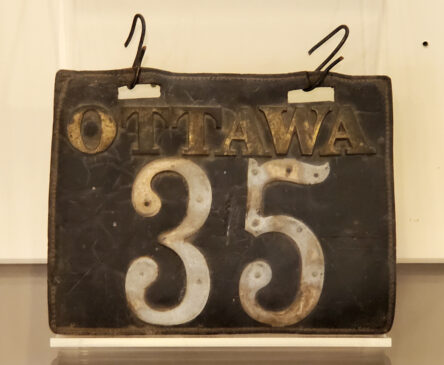A black leather license plate with the name "Ottawa" and number 35 in metal.