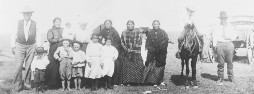 Kickapoo/Kiwigapawa tribe members standing in front of a tent 1909