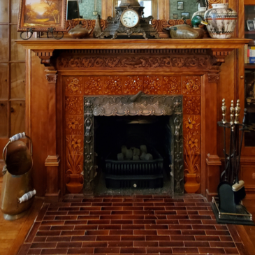 Image of a Victorian fire place with a ceramic surround.
