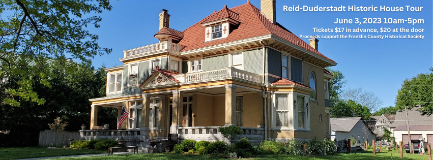 2 1/2 story Italian Renaissance Revival house with a tile roof, brick first floor, and wrap-around porch.